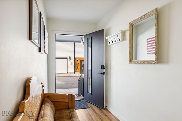 entryway with light wood-type flooring and baseboards