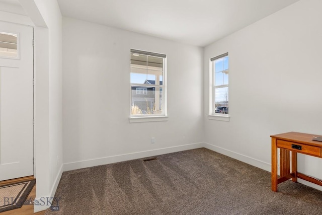carpeted empty room with baseboards and visible vents