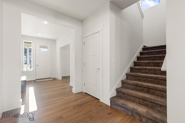 entryway featuring stairway, recessed lighting, baseboards, and wood finished floors