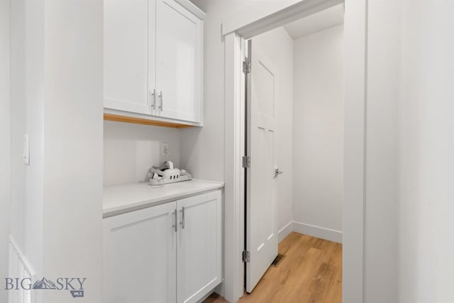 interior space featuring light wood-style flooring and baseboards