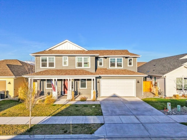 traditional-style home with covered porch, a garage, concrete driveway, board and batten siding, and a front lawn