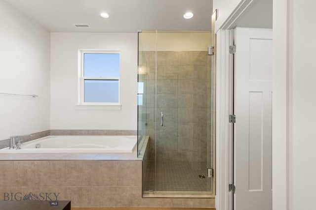bathroom with a stall shower, recessed lighting, a garden tub, and visible vents