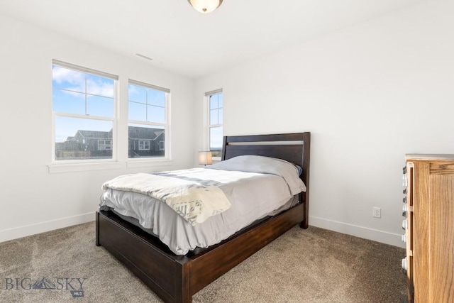 carpeted bedroom with baseboards