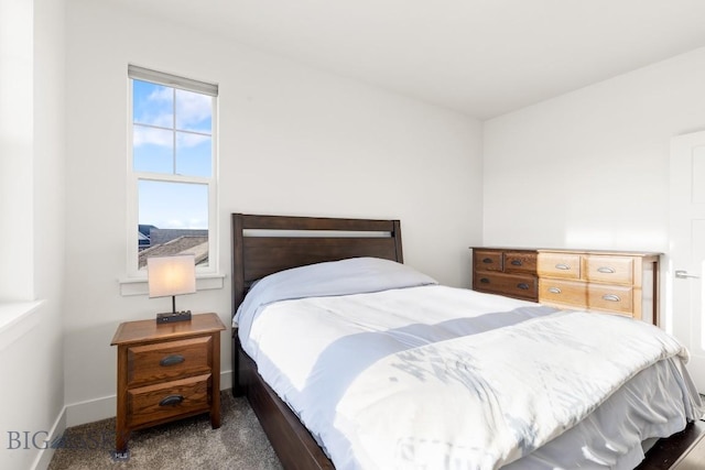 carpeted bedroom featuring baseboards