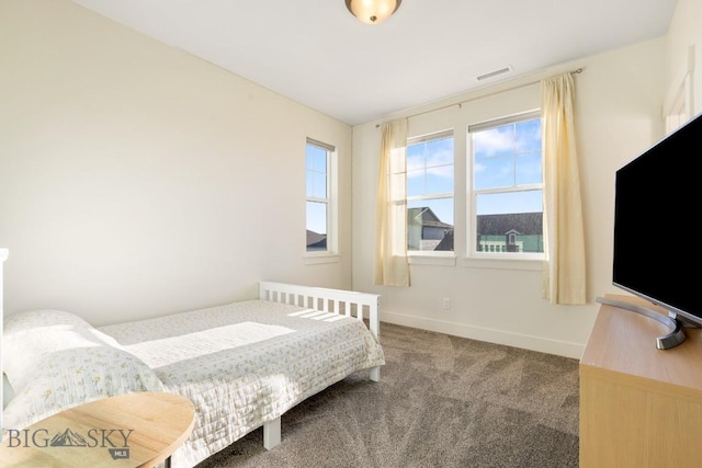 bedroom with baseboards, carpet flooring, and visible vents