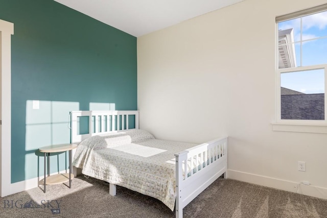 bedroom featuring carpet and baseboards