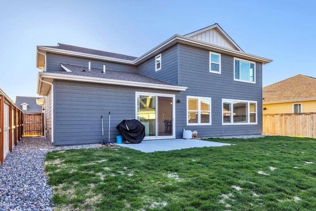 rear view of house with a yard, a patio, and a fenced backyard