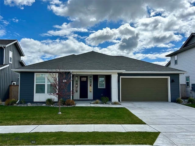 ranch-style home featuring driveway, a garage, and a front yard