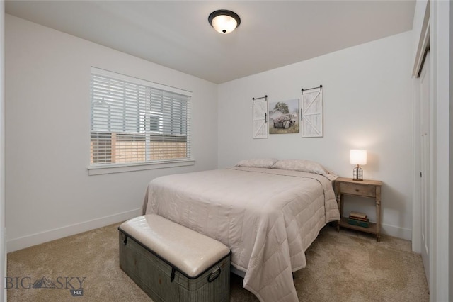 carpeted bedroom featuring a closet and baseboards