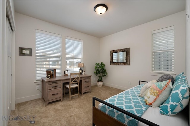 bedroom with light carpet and baseboards