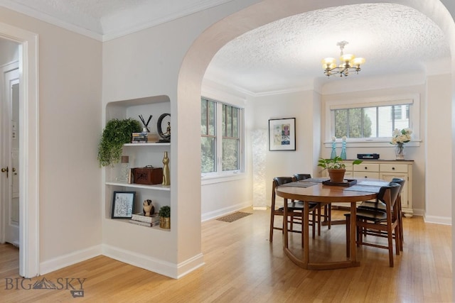 1014 S 6th St, Bozeman, MT 59715 - dining room featuring arched walkways, a notable chandelier, light wood-style floors, and a textured ceiling