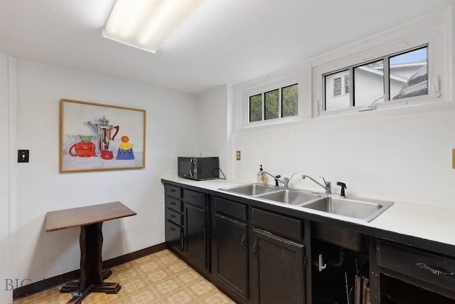 1014 S 6th St, Bozeman, MT 59715 - kitchen with light floors, baseboards, a sink, black microwave, and light countertops