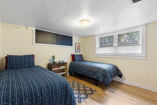 1014 S 6th St, Bozeman, MT 59715 - bedroom featuring a textured ceiling, wood finished floors, and baseboards