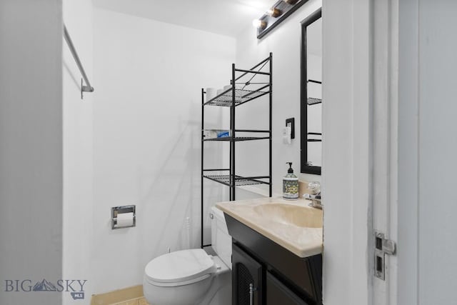 1014 S 6th St, Bozeman, MT 59715 - half bath featuring toilet, baseboards, and vanity