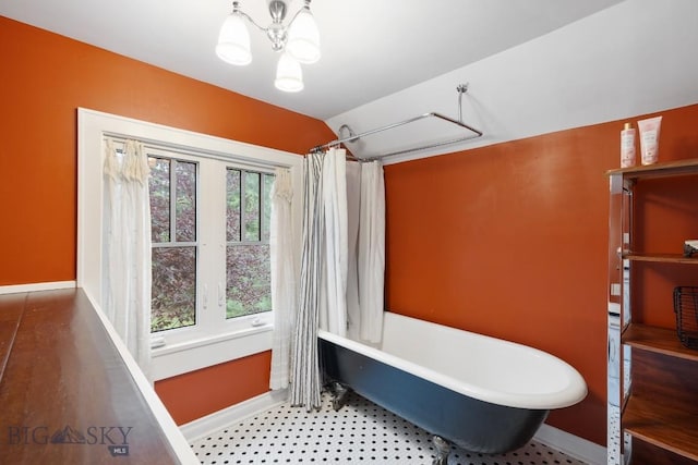 1014 S 6th St, Bozeman, MT 59715 - full bath with a shower with curtain, a chandelier, a freestanding bath, baseboards, and vaulted ceiling