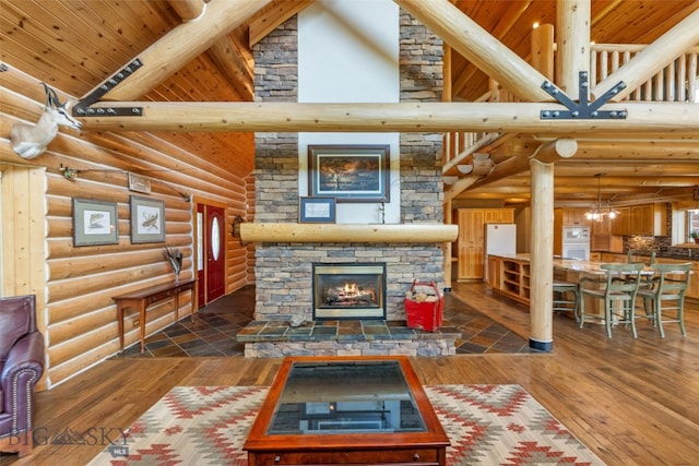 living area featuring rustic walls, a fireplace, high vaulted ceiling, and wood ceiling