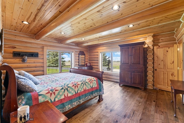 bedroom featuring hardwood / wood-style floors, log walls, recessed lighting, beamed ceiling, and access to exterior