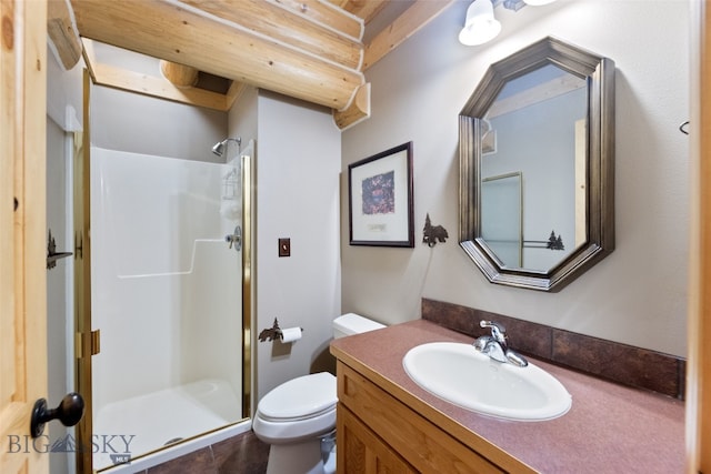 bathroom featuring a stall shower, vanity, and toilet