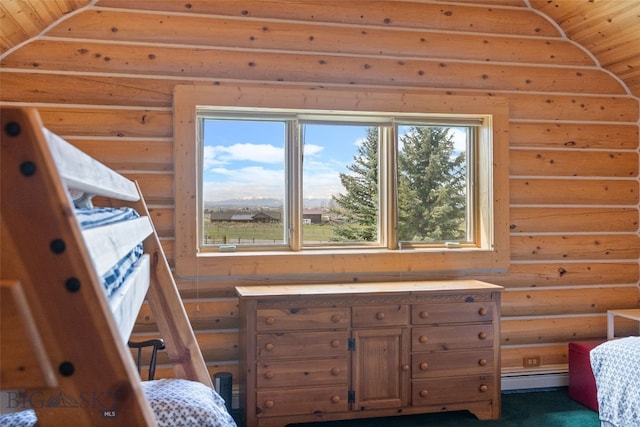 bedroom with a baseboard radiator and log walls
