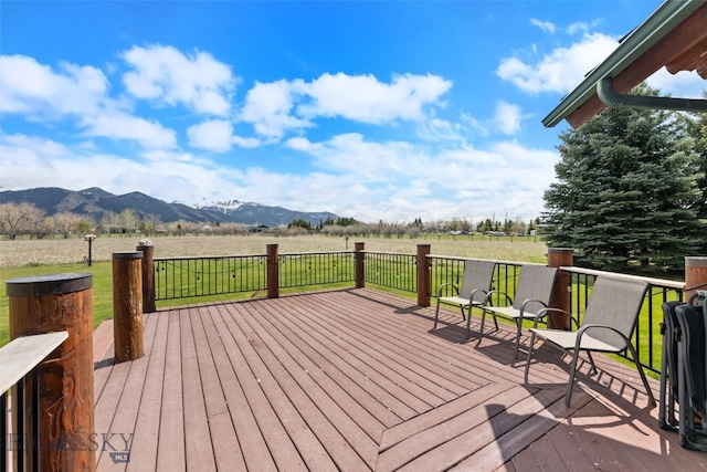 deck with a rural view and a mountain view