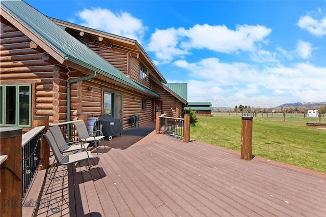 deck featuring a yard, area for grilling, and a mountain view