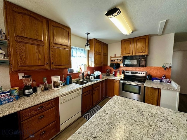 200 Missoula, Butte, MT 59701 - kitchen with white dishwasher, brown cabinetry, a sink, stainless steel electric stove, and black microwave