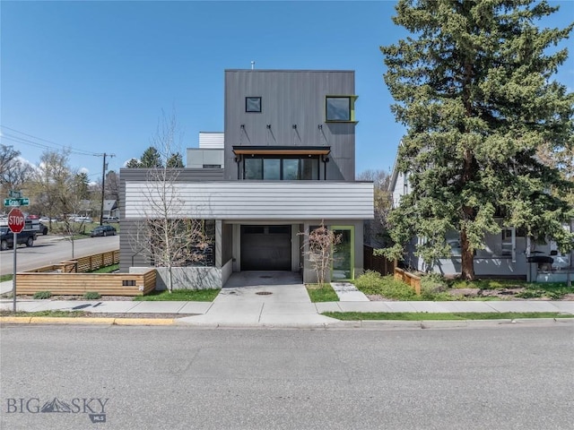 contemporary home featuring fence and a balcony