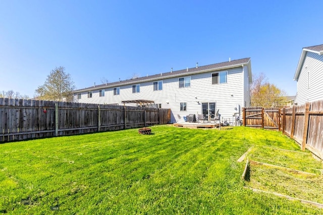 116 Michael Grove Ave, Bozeman, MT 59718 - back of house with a yard, a fenced backyard, a vegetable garden, and a fire pit