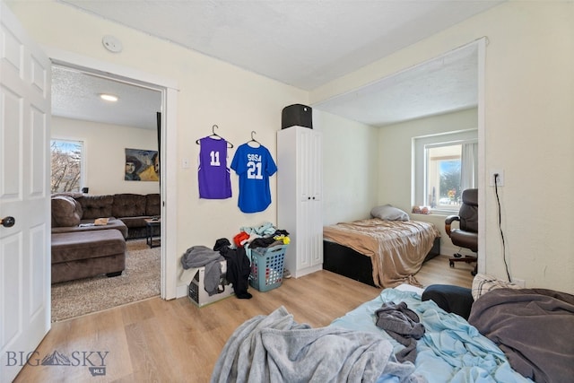 502 W Front St, Livingston, MT 59047 - bedroom with a textured ceiling, multiple windows, and wood finished floors