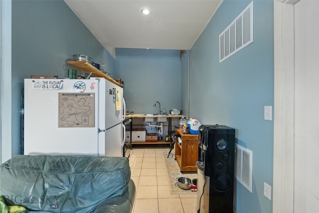502 W Front St, Livingston, MT 59047 - kitchen with freestanding refrigerator, visible vents, and light tile patterned flooring