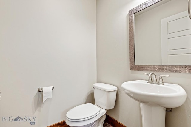 3598 Annie St, Bozeman, MT 59718 - bathroom with toilet, a sink, and baseboards