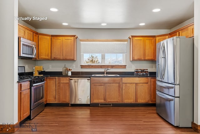 3598 Annie St, Bozeman, MT 59718 - kitchen with stainless steel appliances, a sink, dark countertops, recessed lighting, and dark wood-style floors