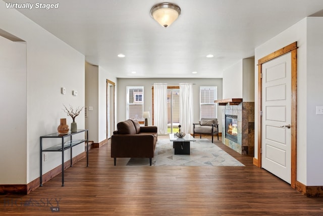 3598 Annie St, Bozeman, MT 59718 - living room featuring wood finished floors, baseboards, a tiled fireplace, and recessed lighting