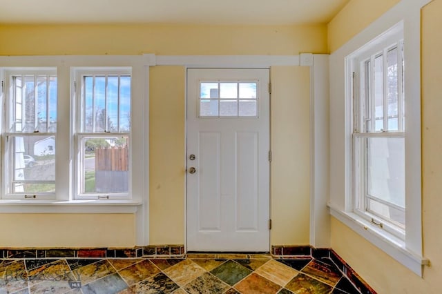 entryway with stone finish flooring and a healthy amount of sunlight