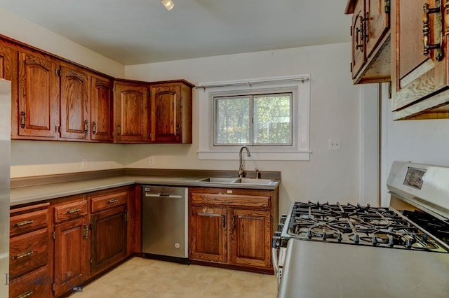 kitchen with brown cabinets, appliances with stainless steel finishes, and a sink