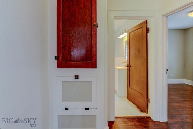 interior space with wood finished floors and baseboards