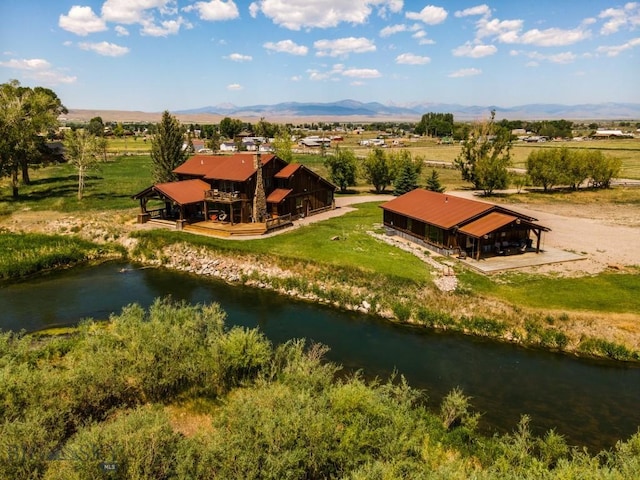 bird's eye view with a water and mountain view and a rural view