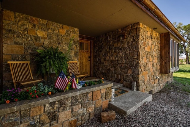 doorway to property with stone siding