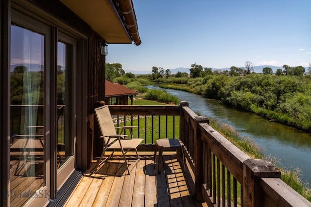 deck featuring a water and mountain view