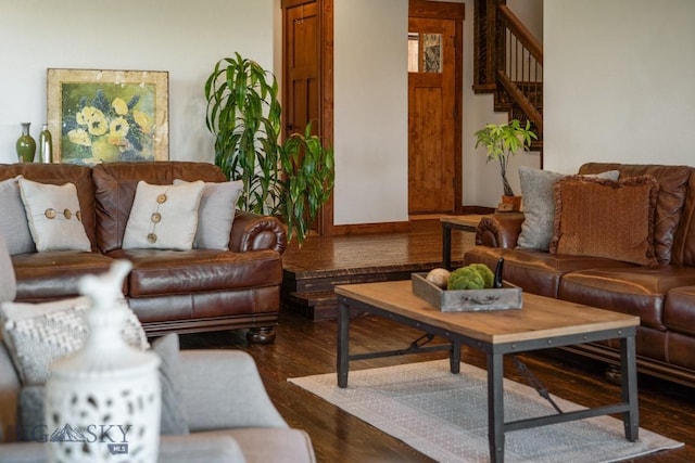 living room with dark wood finished floors and stairs