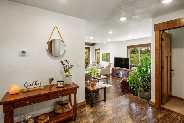 living room featuring baseboards, recessed lighting, and dark wood-style floors