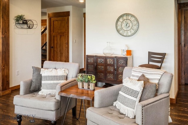 sitting room with wood finished floors, stairway, and baseboards