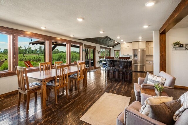 dining room featuring dark wood-style flooring, a textured ceiling, baseboards, and recessed lighting