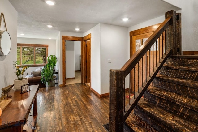 stairway featuring baseboards, recessed lighting, and wood finished floors