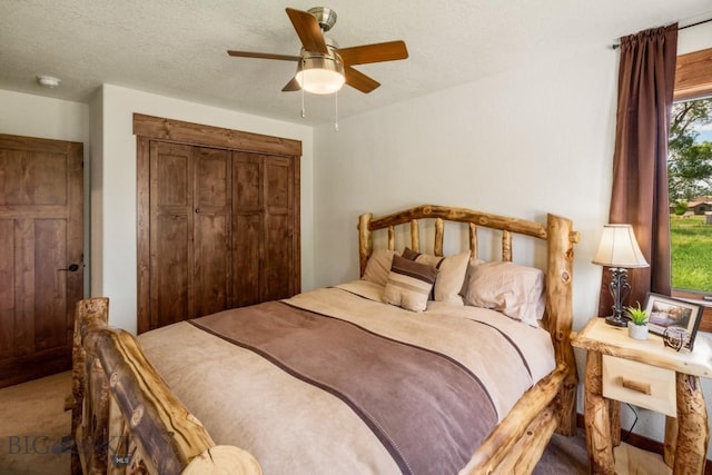 carpeted bedroom with a ceiling fan and a closet