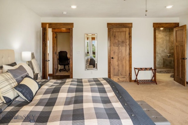 carpeted bedroom featuring a walk in closet, ensuite bathroom, and recessed lighting