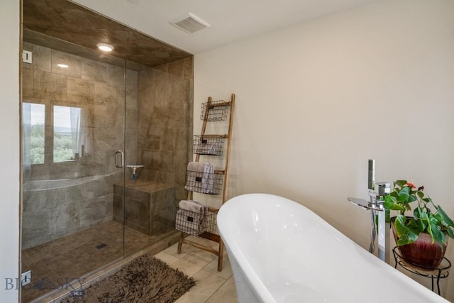 full bath featuring a stall shower, tile patterned floors, visible vents, and a freestanding tub