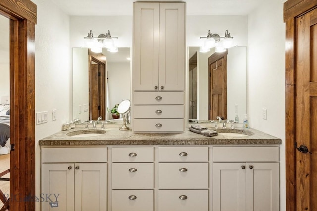 bathroom featuring a sink and double vanity