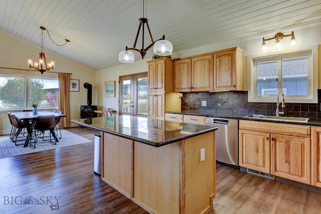 kitchen with stainless steel dishwasher, an inviting chandelier, a sink, a wood stove, and dark wood-style floors