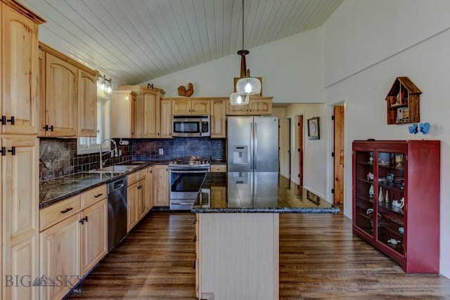 kitchen with crown molding, appliances with stainless steel finishes, vaulted ceiling, and a sink